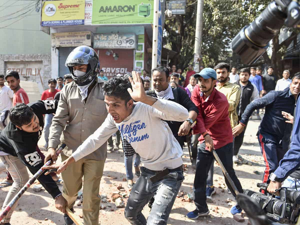 : Protestors during clashes between a group of anti-CAA protestors and supporters of the new citizenship act, at Jafrabad in north-east Delhi, Monday