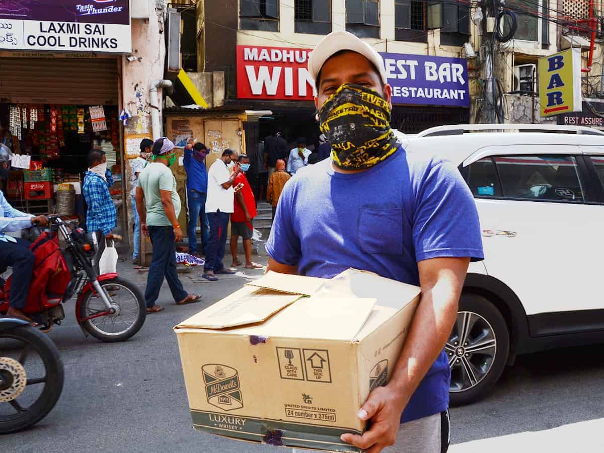Liquor shops reopen in Telangana, tipplers throng stores