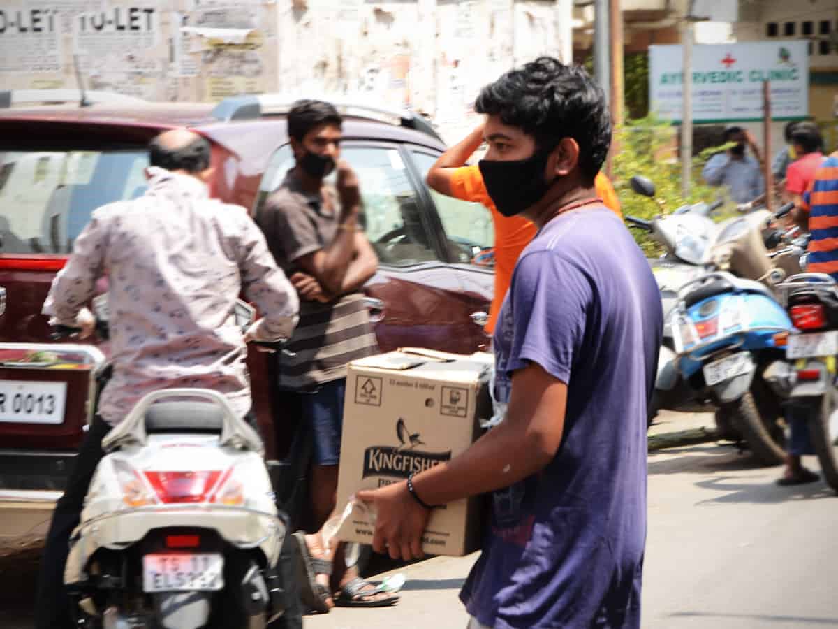 Liquor shops reopen in Telangana, tipplers throng stores